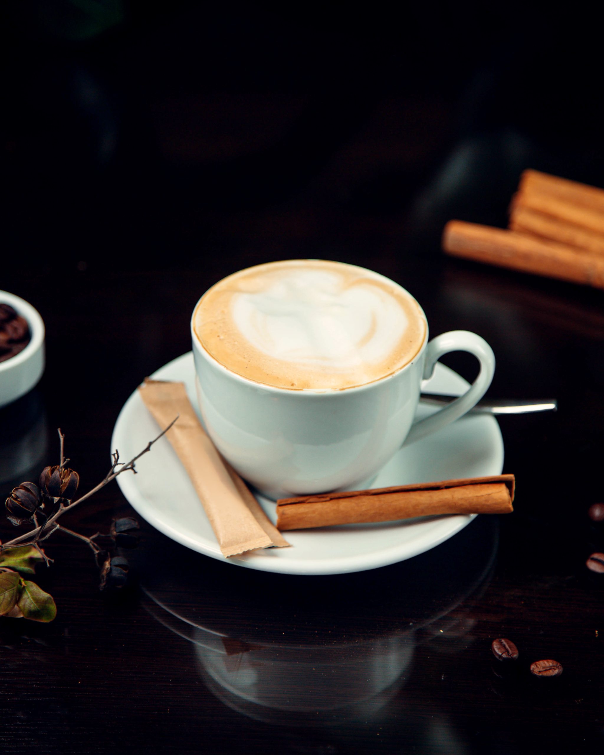 coffee with whipped cream and side cinnamon